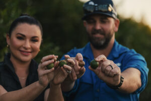 Photo of Rhys & Sara Abdy with Australian macadamia nuts they have grown