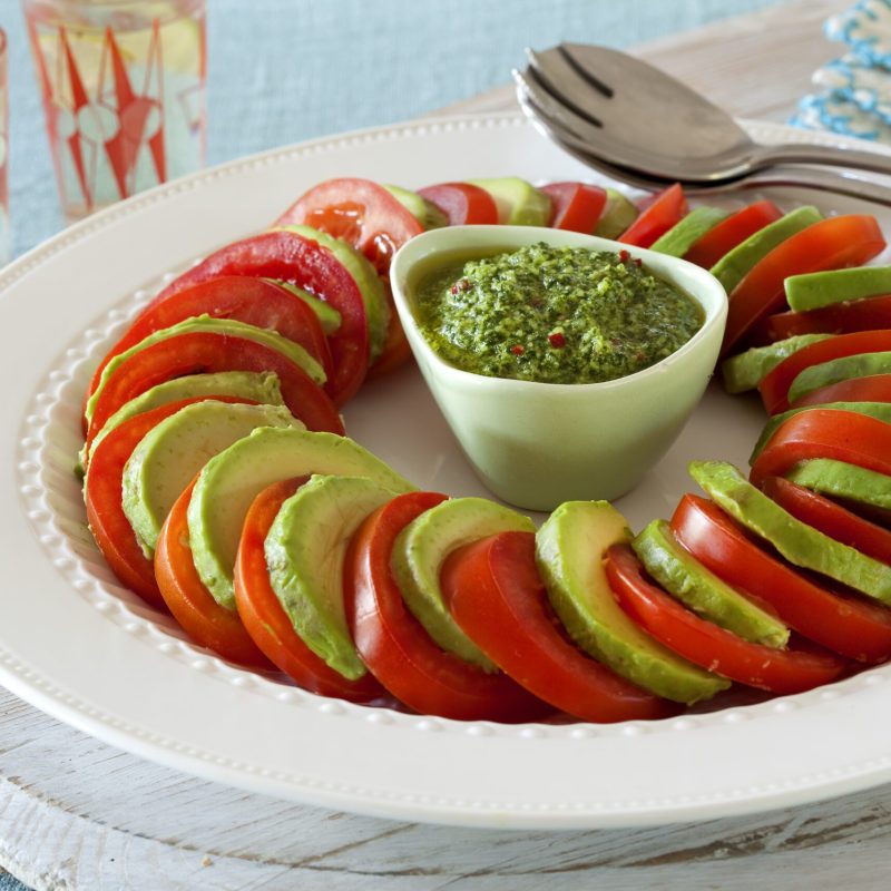 Tomato and avocado salad with macadamia and coriander dressing