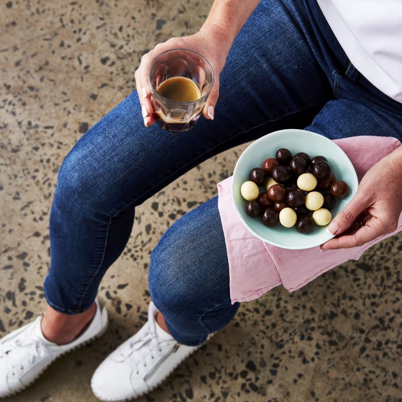 Chocolate coated macadamias and coffee
